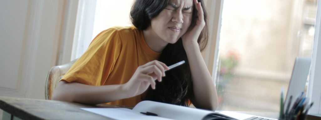 Woman having headache over corporate tax penalties